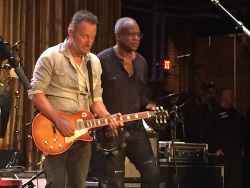 David Sancious and Bruce Springsteen playing guitar on stage